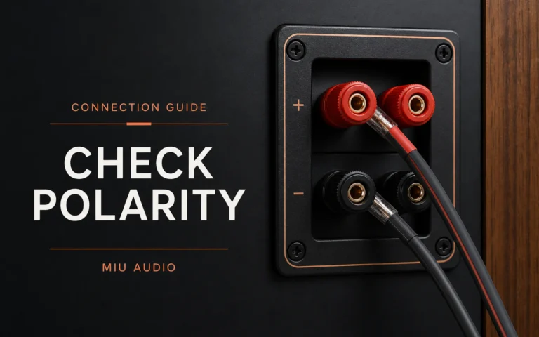 Red and black loudspeaker terminals with correctly routed cable beside the words Check Polarity